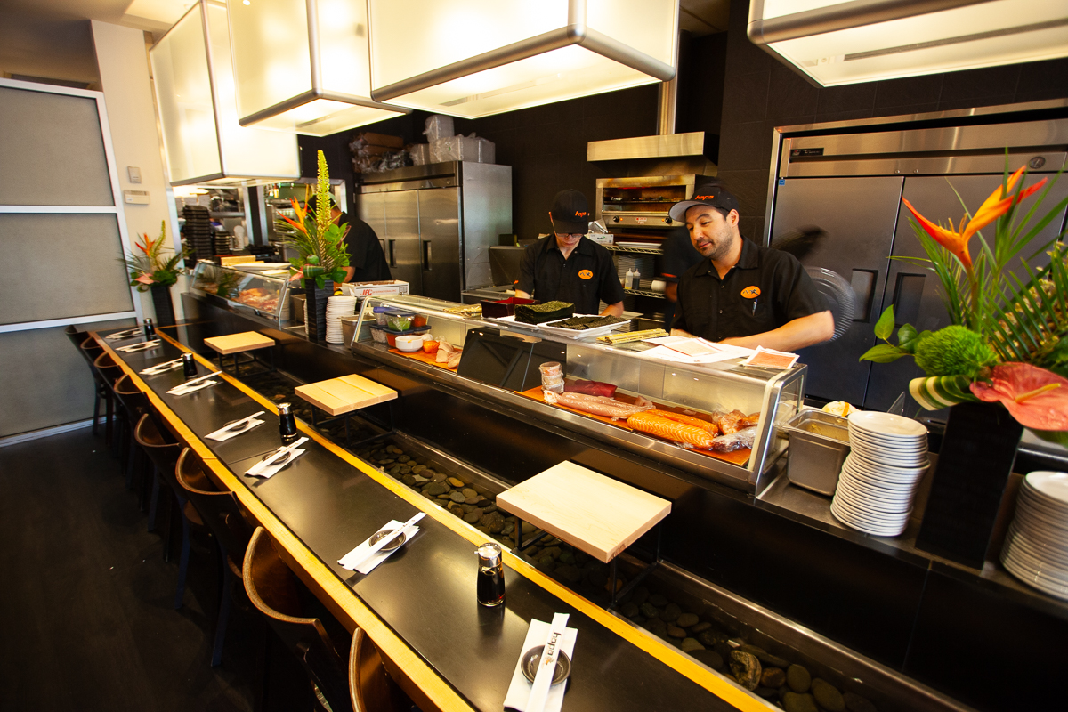 Sushi chefs working their magic on these amazing dishes.