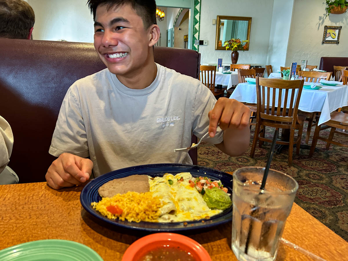 Diego eating Los Tios Shrimp Enchiladas