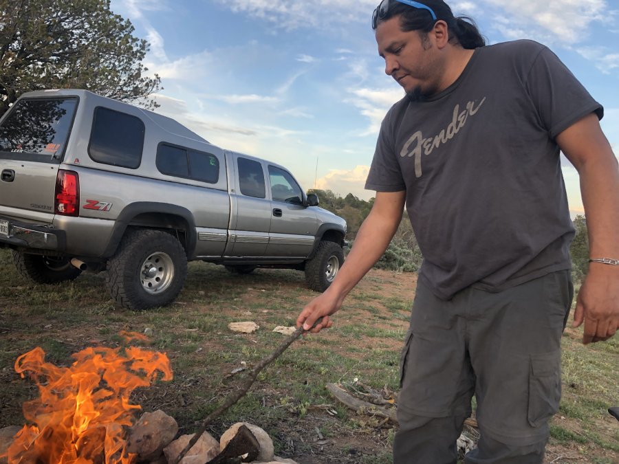 Abel wearing the REI Convertible Pants at camp