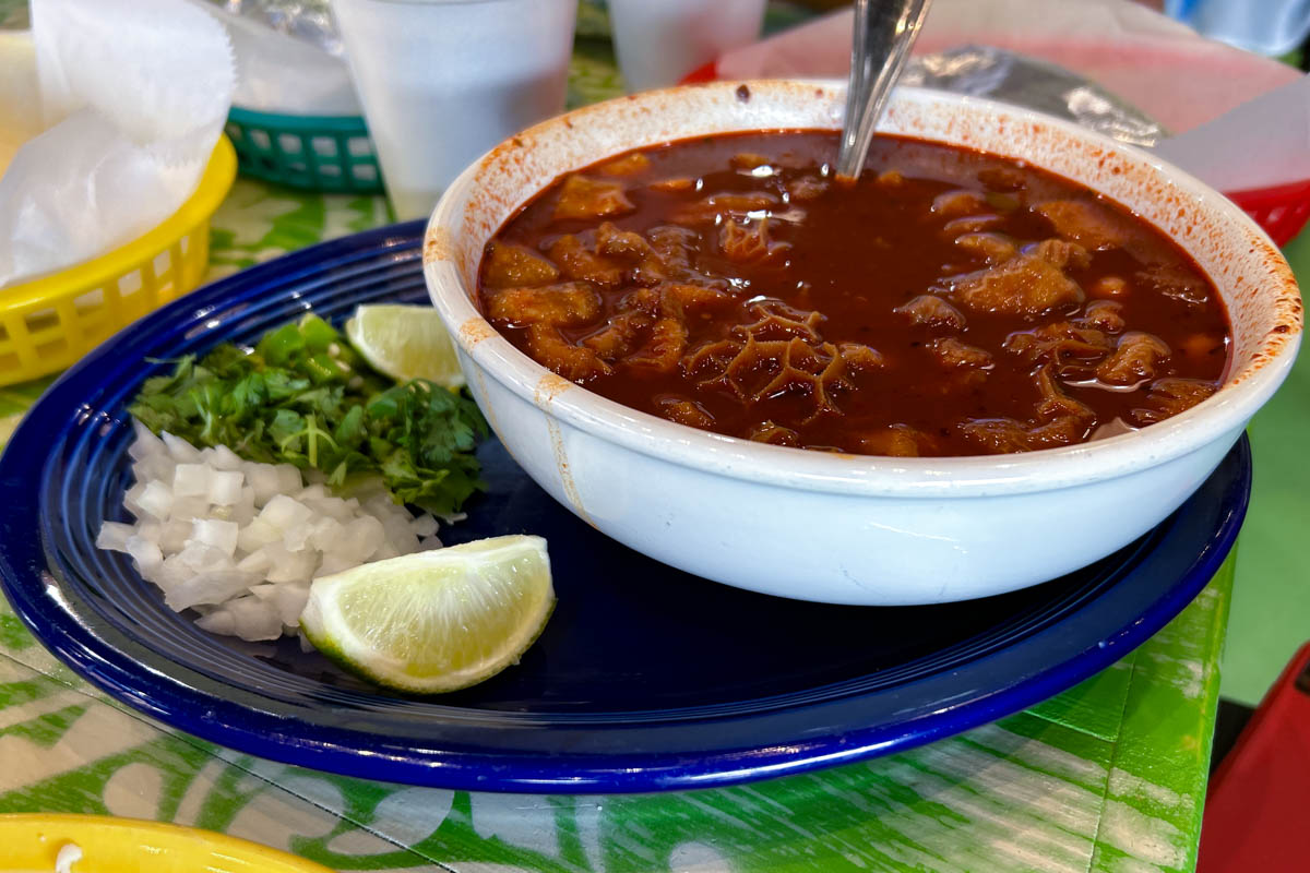 Large bowl of Menudo with cilantro, onions and lime