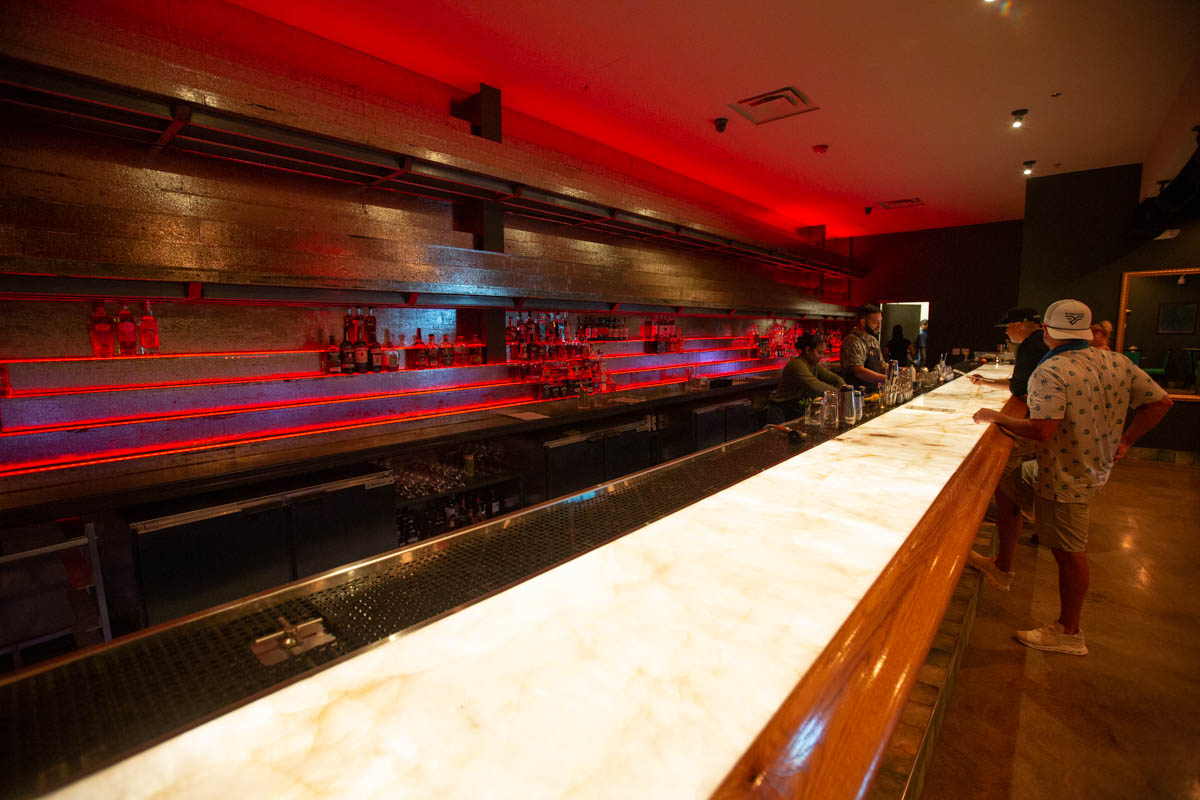 The cocktail bar is glowing from lights under