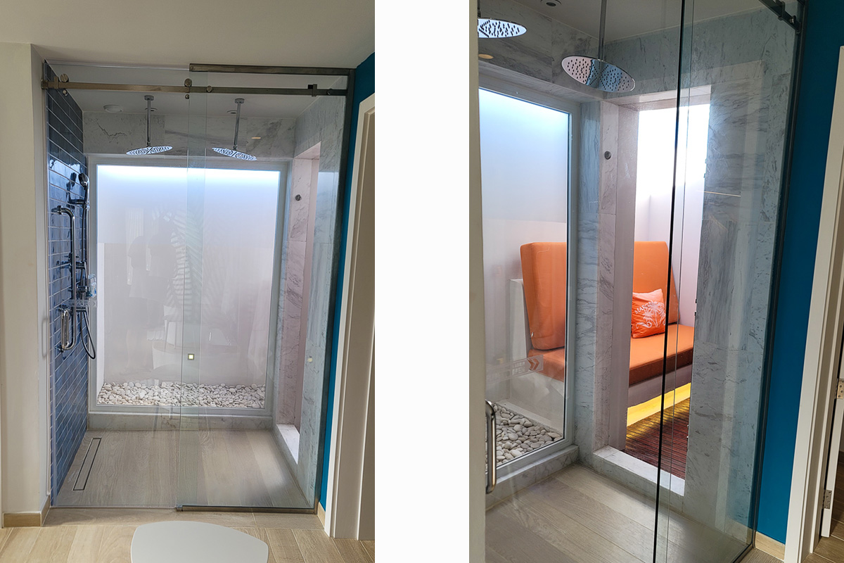 >Walk-in shower with rain shower heads.